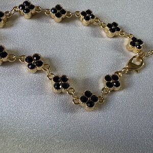 Gold-Tone Bracelet with Black Crystal Clover Accents